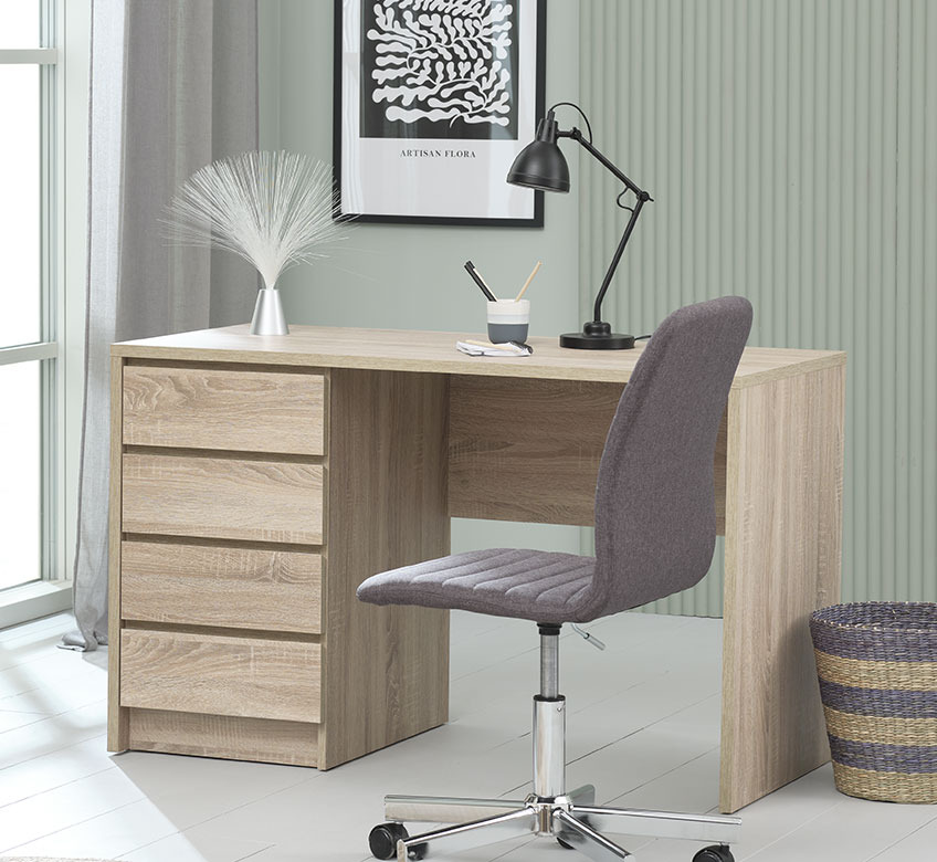 Desk with table lamp, office chair and wastepaper bin in office 