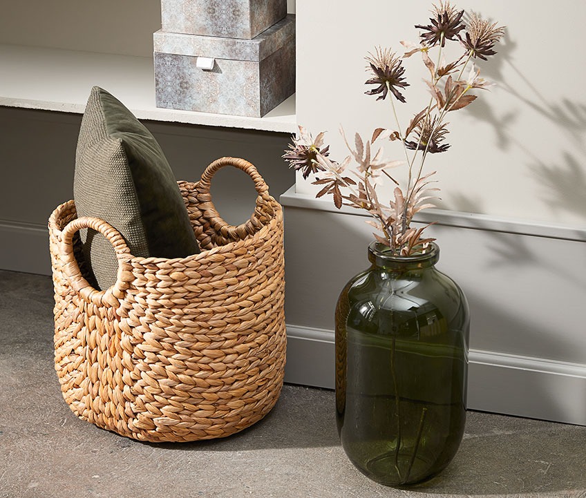 Green floor vase and a basket with a cushion